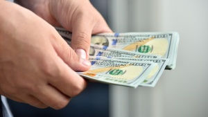 Businessman hands counting hundred dollar bills for Bitcoin ATMs and Digital Wallets