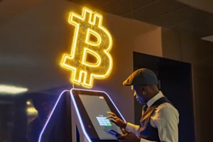 black man using bitcoin atm